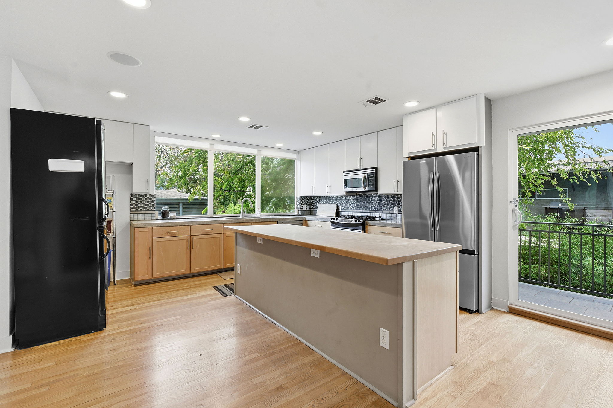 616 West Monroe Street Austin, TX 78704 - Photo 3 of 14 a kitchen with white cabinets and white appliances