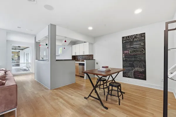 a view of a dining room with furniture and wooden floor