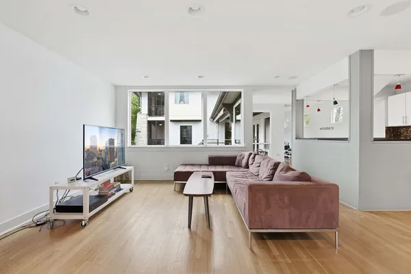 a living room with furniture and a wooden floor