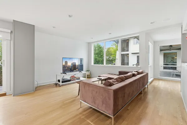 a living room with furniture window and a flat screen tv