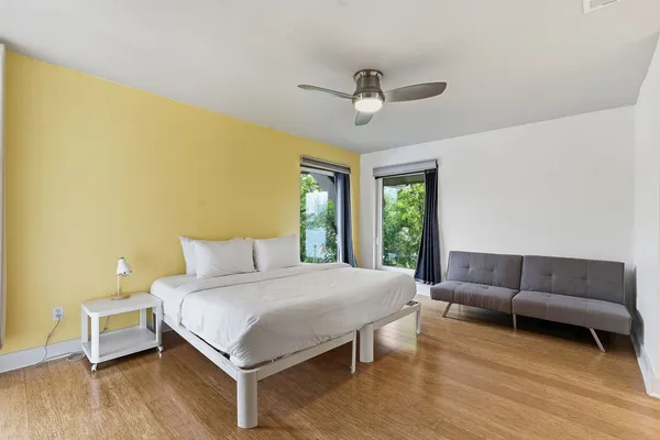 a bedroom with a bed couch and window