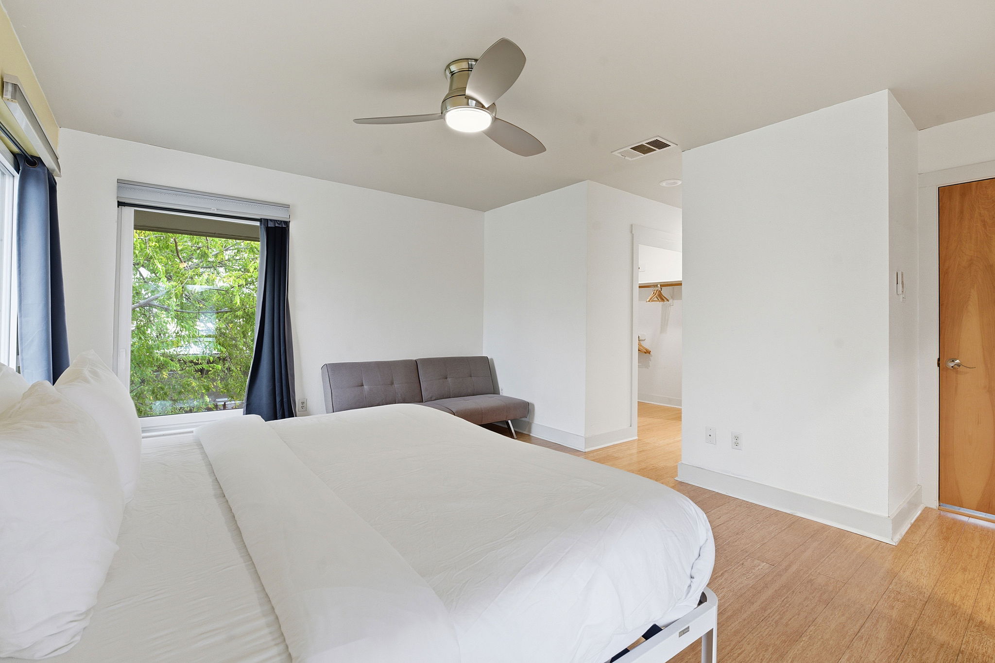 616 West Monroe Street Austin, TX 78704 - Photo 9 of 14 a bedroom with a large bed and a chandelier