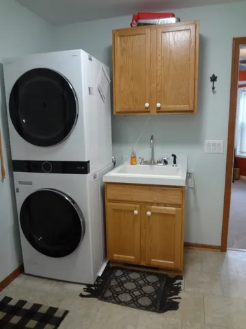 a utility room with sink dryer and washer
