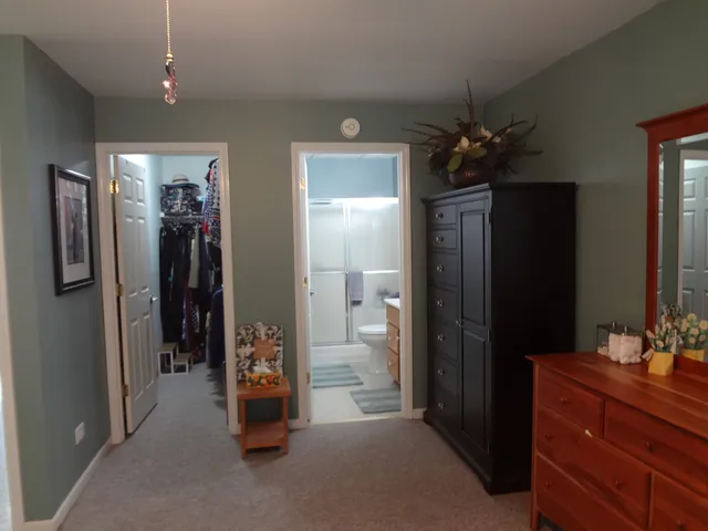 a view of a hallway with closet and a mirror