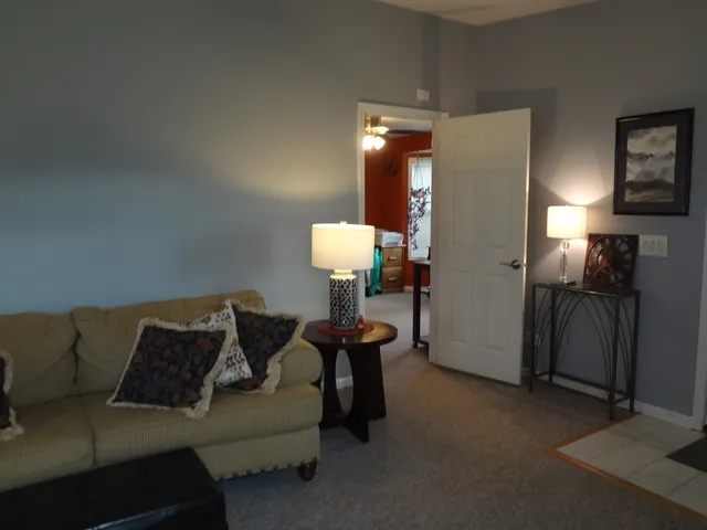 a living room with furniture and a lamp