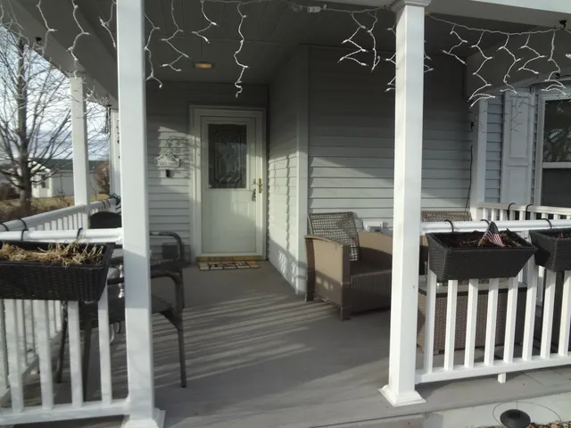a view of a porch with wooden fence