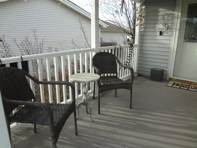 a view of a two chairs and table in the balcony