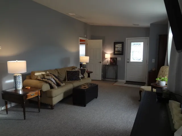 a living room with furniture and a lamp
