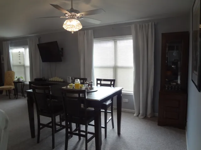 a view of a dining room with furniture and a chandelier