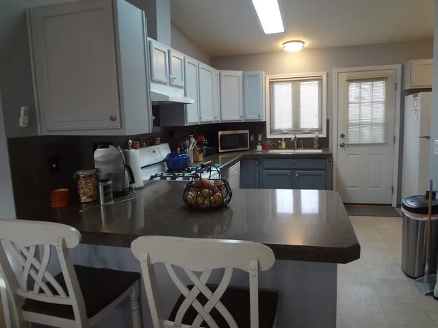 a kitchen with a table chairs and a stove top oven