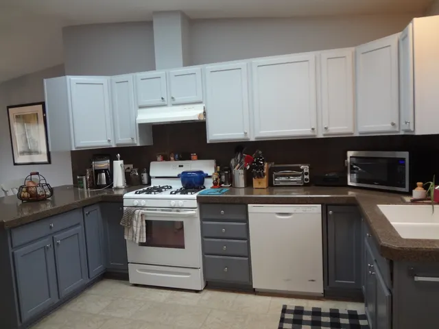 a kitchen with cabinets appliances and a sink