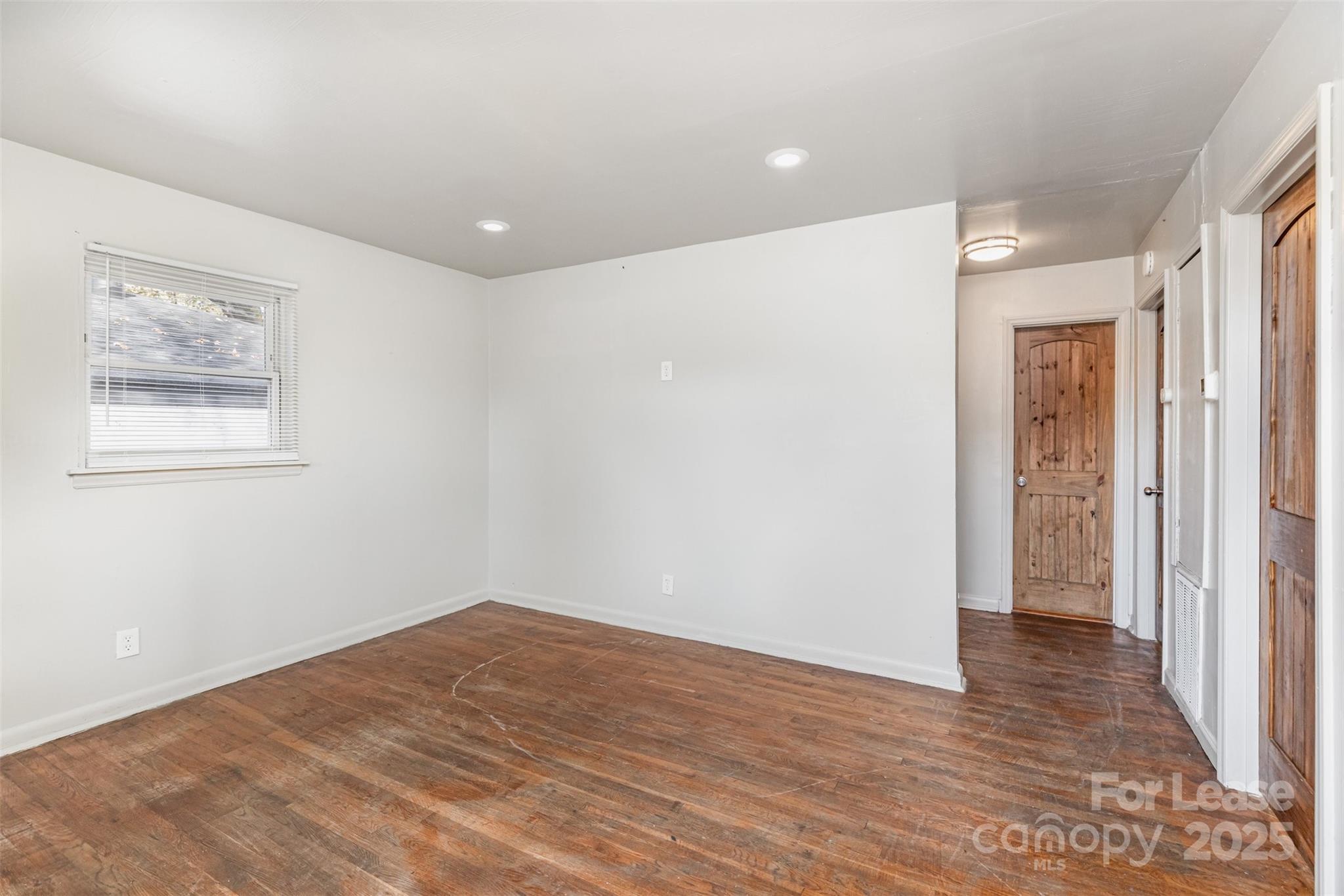 2317 Julia Avenue, Unit 3 Charlotte, NC 28206 - Photo 4 of 12 a view of an empty room with wooden floor and closet
