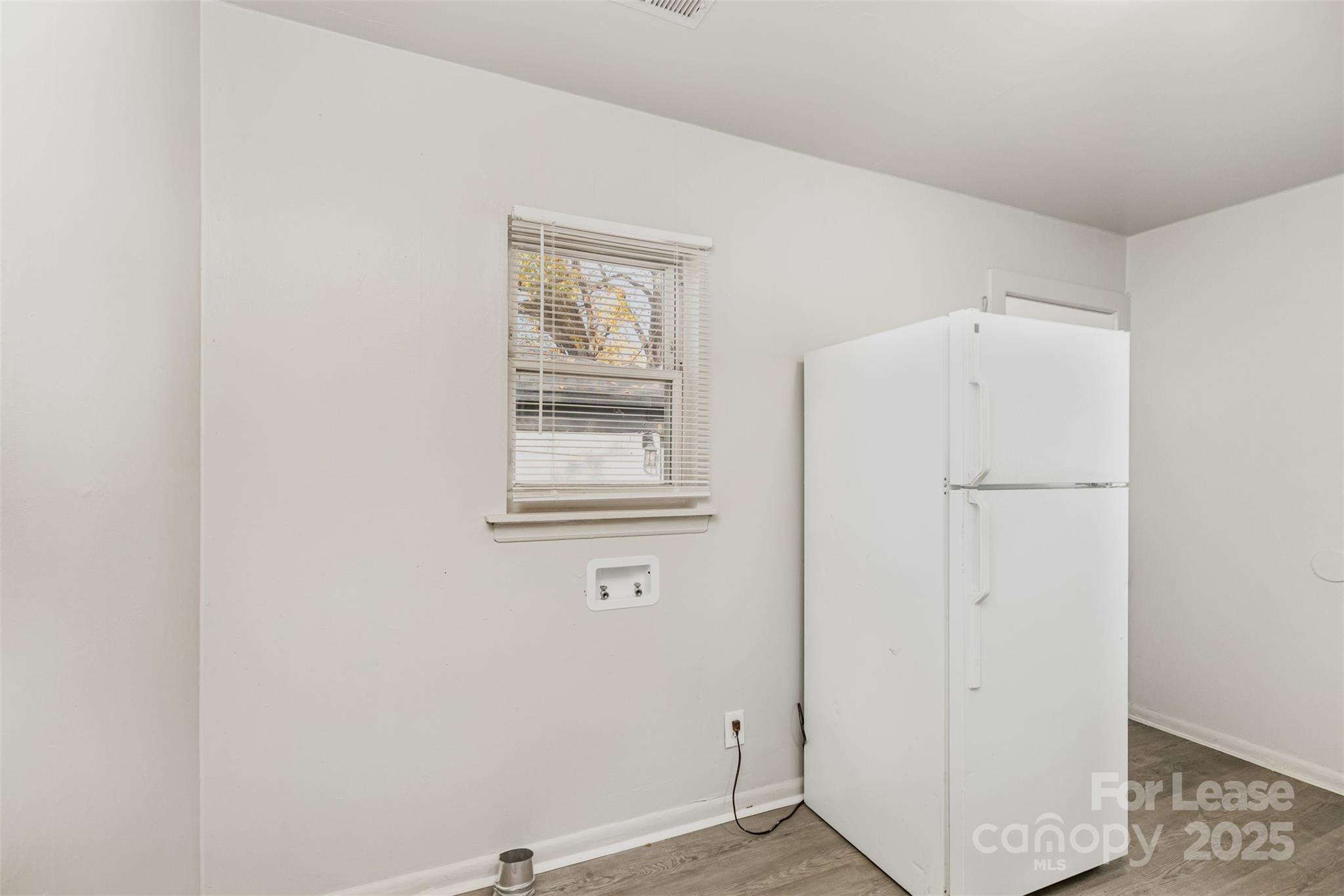 2317 Julia Avenue, Unit 3 Charlotte, NC 28206 - Photo 6 of 12 a view of a livingroom with wooden floor and a window