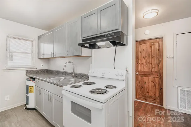 a kitchen with a sink stove and cabinets