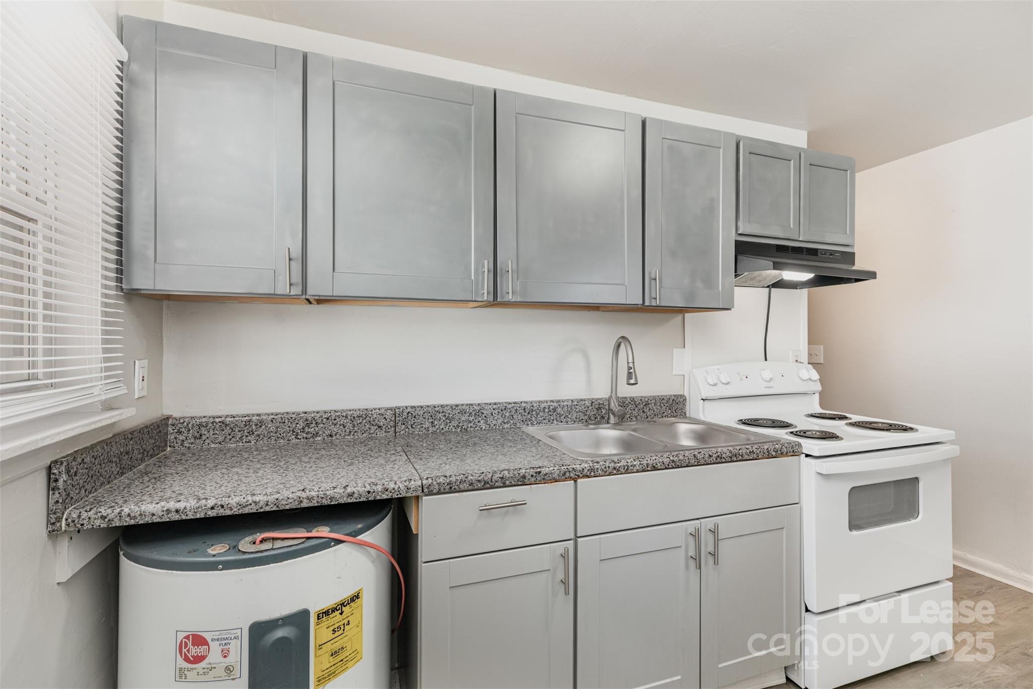 2317 Julia Avenue, Unit 3 Charlotte, NC 28206 - Photo 8 of 12 a kitchen with granite countertop cabinets sink and stainless steel appliances