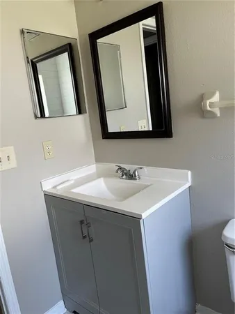 a bathroom with a sink a mirror and vanity