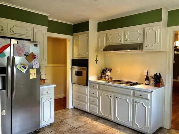 a kitchen with stainless steel appliances a refrigerator sink and cabinets