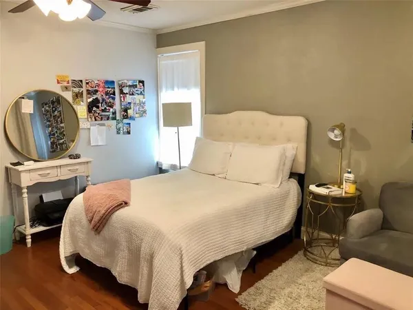 a bedroom with a bed and a chair