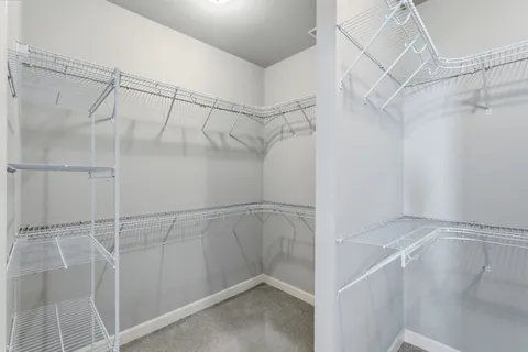 an empty room with a ceiling fan and a window