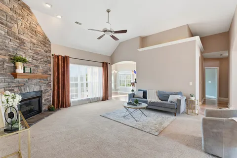 a living room with furniture and a fireplace