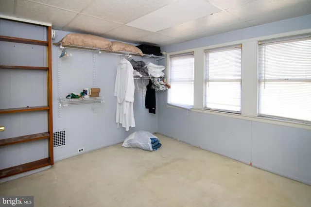 a view of a storage room with water heater and racks