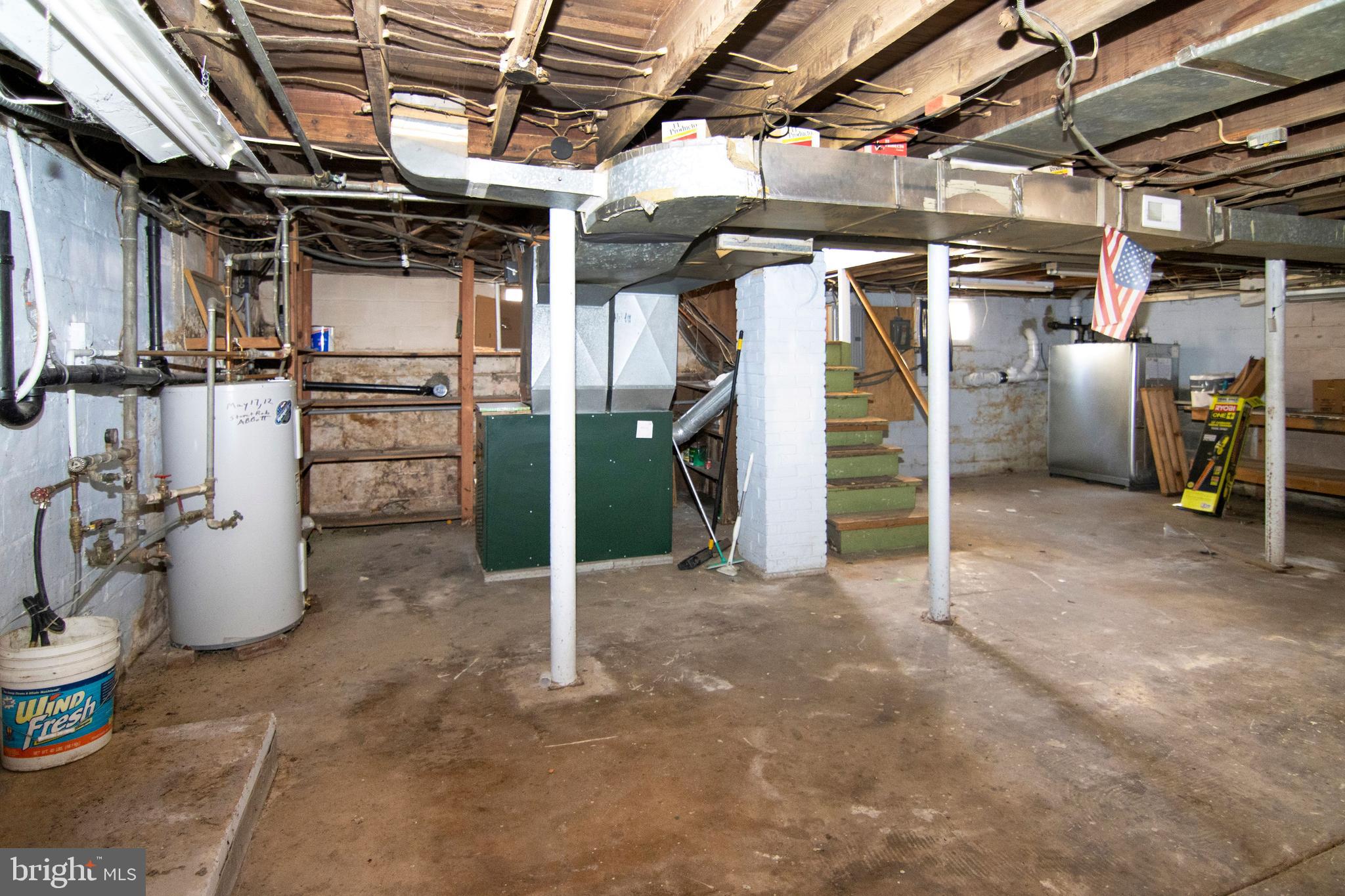 542 Williamstown Road Sicklerville, NJ 08081 - Photo 27 of 38 a view of a storage room with water heater and racks