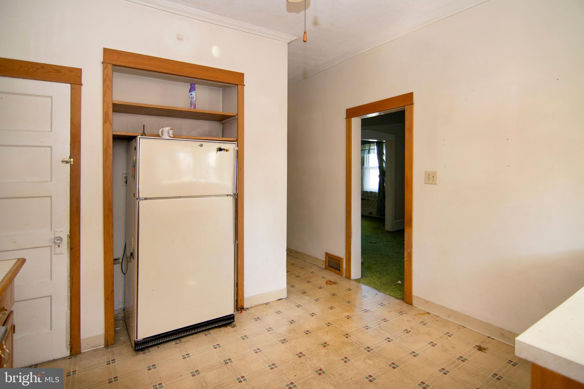 542 Williamstown Road Sicklerville, NJ 08081 - Photo 9 of 38 a view of a hallway with wooden floor and a refrigerator