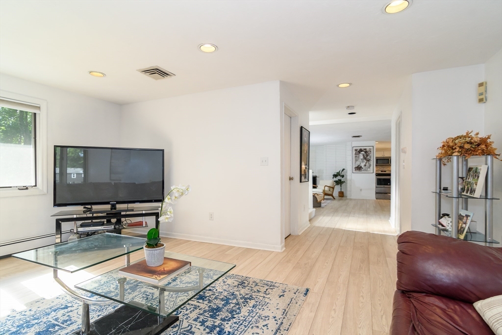 9 Liberty Street Natick, MA 01760 - Photo 11 of 27 a living room with furniture and a flat screen tv