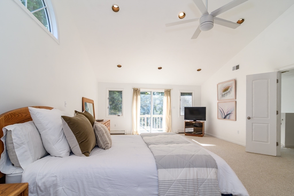 9 Liberty Street Natick, MA 01760 - Photo 17 of 27 a bedroom with a large bed a flat tv screen and a large window