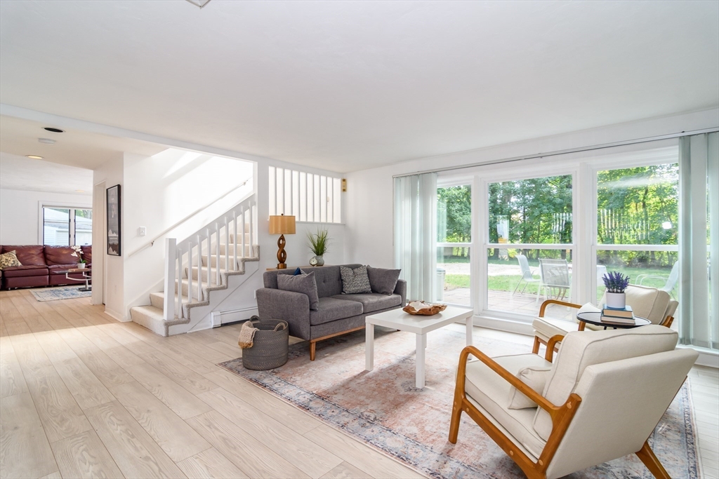 9 Liberty Street Natick, MA 01760 - Photo 2 of 27 a living room with furniture and a large window