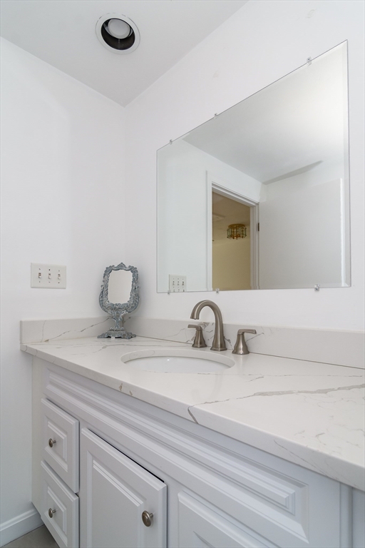 9 Liberty Street Natick, MA 01760 - Photo 22 of 27 a bathroom with a sink and a mirror