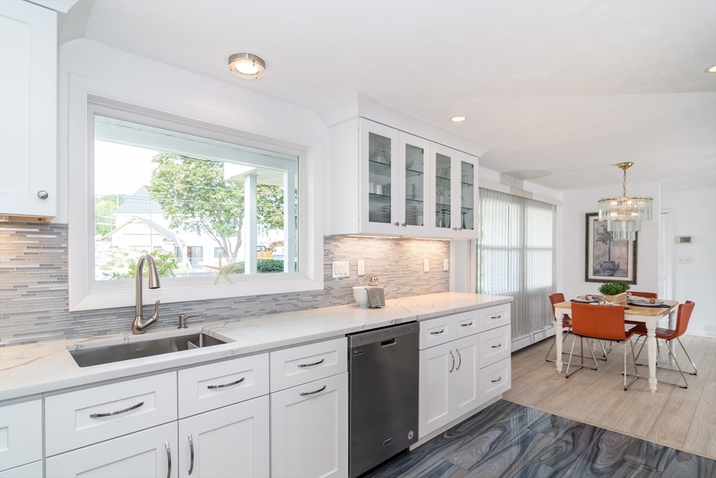 9 Liberty Street Natick, MA 01760 - Photo 6 of 27 a kitchen with granite countertop a sink cabinets and wooden floor