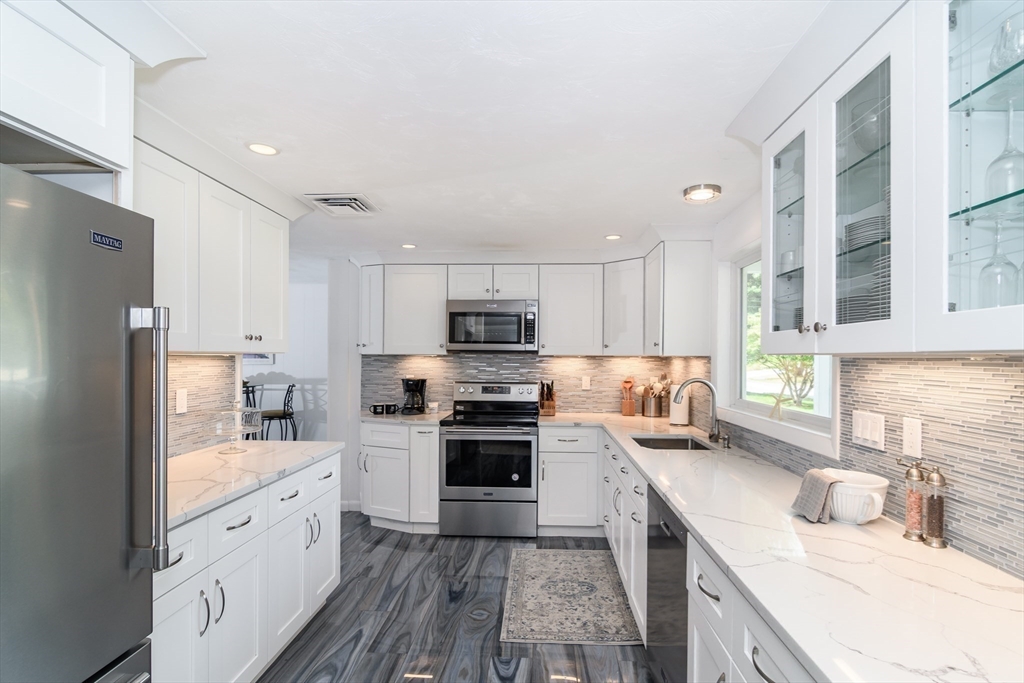 9 Liberty Street Natick, MA 01760 - Photo 7 of 27 a kitchen with stainless steel appliances granite countertop a refrigerator sink and stove