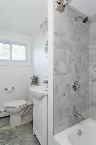 a bathroom with a sink toilet and shower