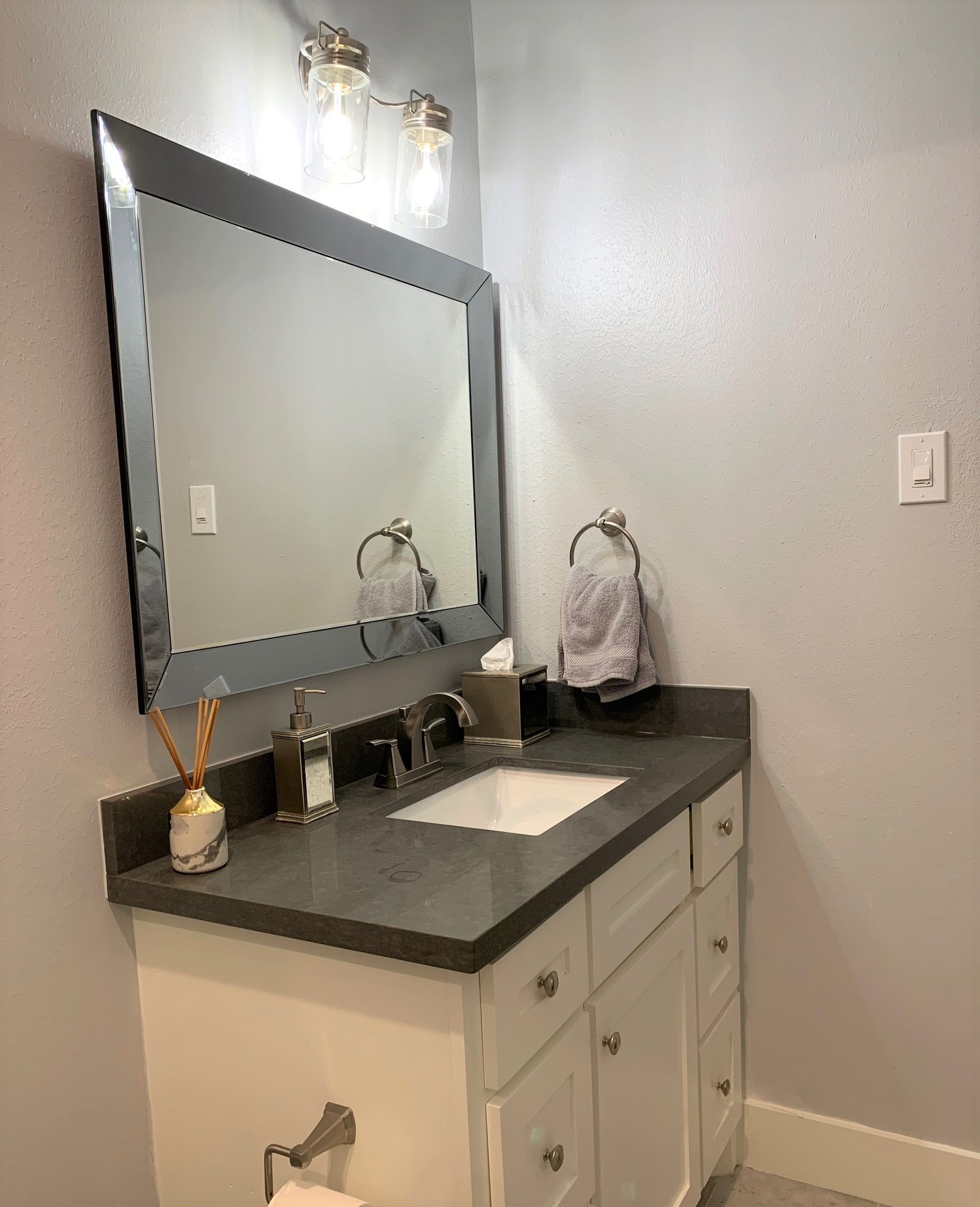 3909 Rice Boulevard Houston, TX 77005 - Photo 11 of 17 a bathroom with a granite countertop sink and a mirror