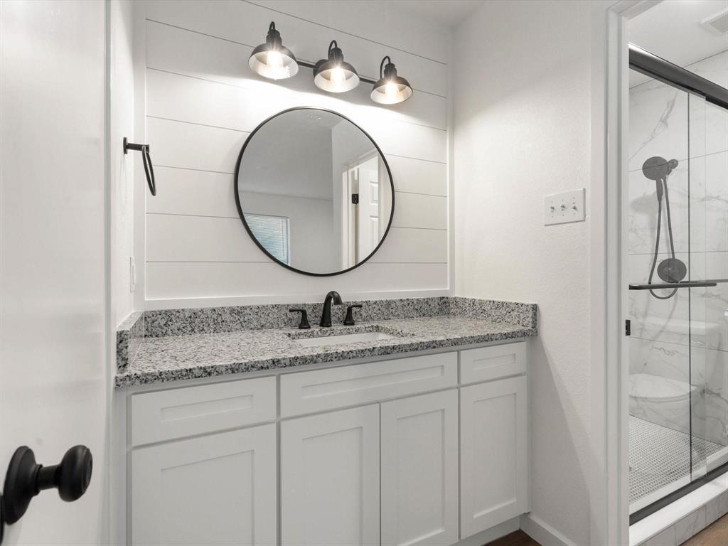 1117 South Rusk Street, Unit 1117 Weatherford, TX 76086 - Photo 8 of 16 Full bathroom featuring vanity and a marble finish shower