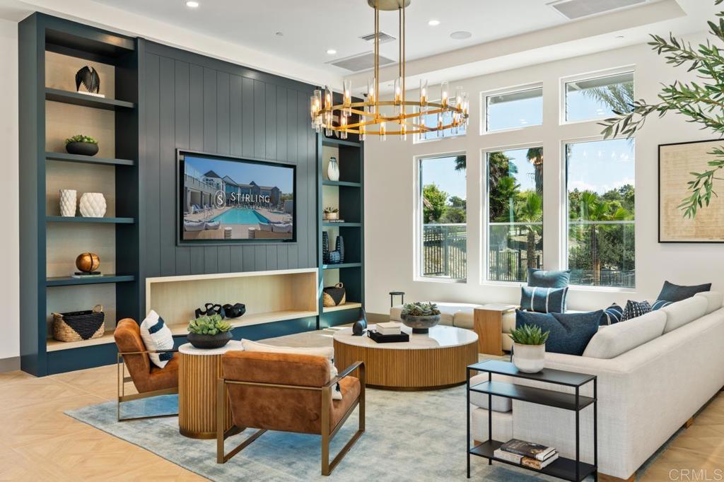 a living room with furniture a chandelier and a dining table