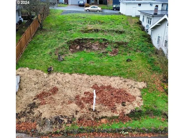 a backyard of a house with a yard and outdoor seating
