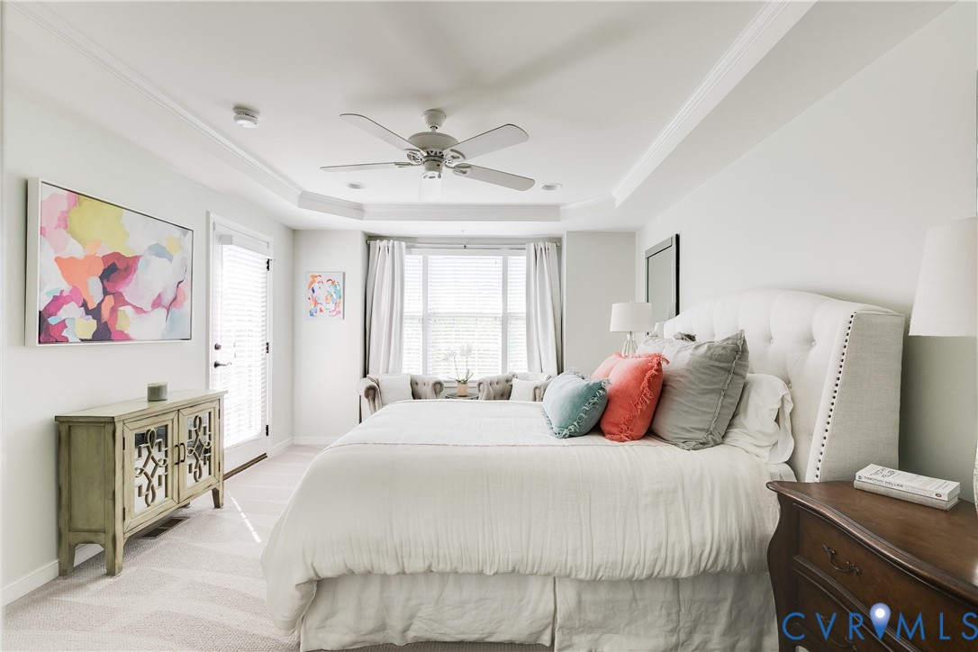 3900 Redbud Road Glen Allen, VA 23060 - Photo 21 of 37 a bedroom with a large bed a chandelier and a painting on the wall