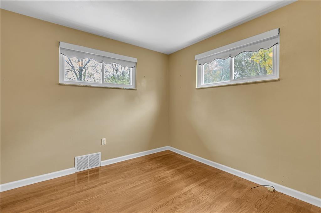142 Wickham Drive Monaca, PA 15061 - Photo 11 of 26 a view of an empty room with wooden floor and a window