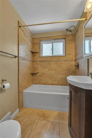 a bathroom with a sink toilet and bathtub