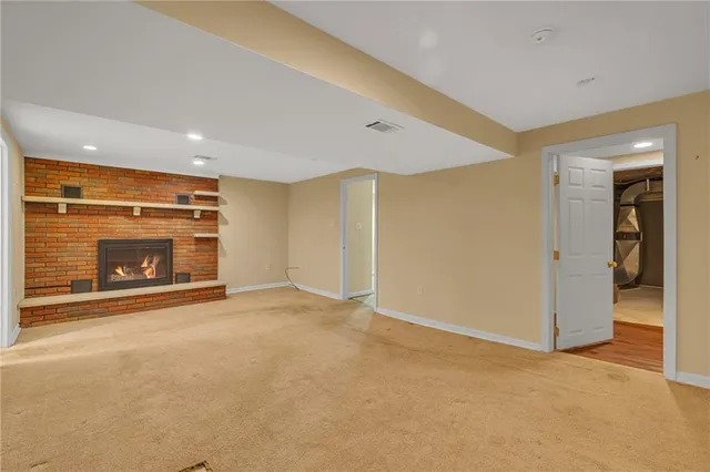a view of empty room with a fireplace