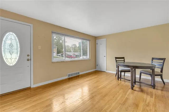 a view of a room with furniture wooden floor and window