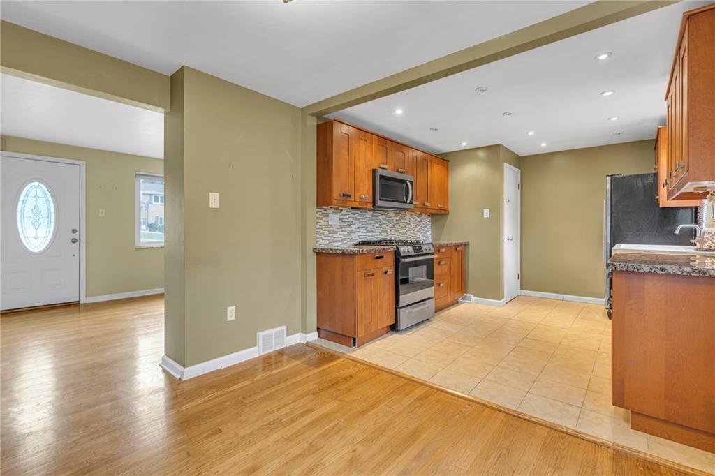 142 Wickham Drive Monaca, PA 15061 - Photo 8 of 26 a open kitchen with stainless steel appliances granite countertop a granite counter tops and a refrigerator