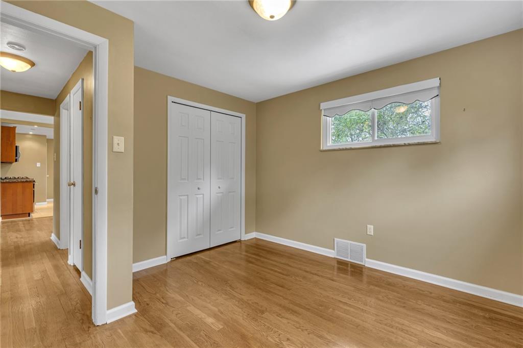 142 Wickham Drive Monaca, PA 15061 - Photo 10 of 26 an empty room with wooden floor and windows
