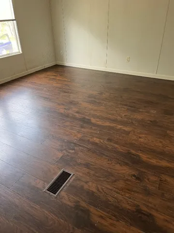 an empty room with wooden floor