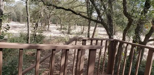 a view of a wooden fence and trees