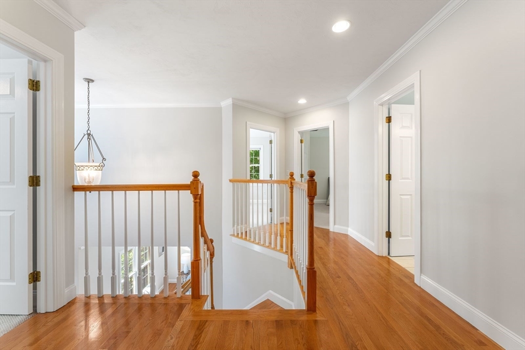 33 Bond Street Needham, MA 02492 - Photo 18 of 35 a view of a hallway with wooden floor and entryway