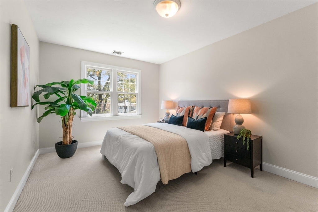 33 Bond Street Needham, MA 02492 - Photo 27 of 35 a bedroom with bed and a potted plant