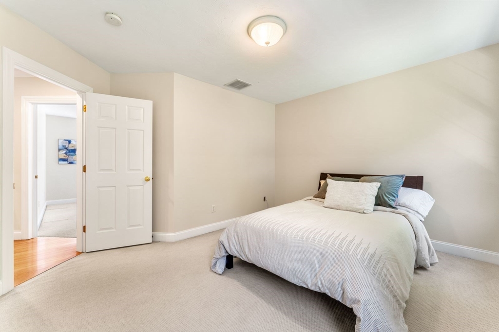 33 Bond Street Needham, MA 02492 - Photo 29 of 35 a bedroom with a bed and a table